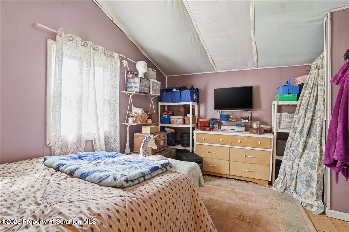 1140 Ball Pond Road Thompson, PA 18465 - Photo 68 of 68 a bedroom with a bed a flat screen tv and a dresser