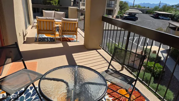 a balcony view with a table and chairs