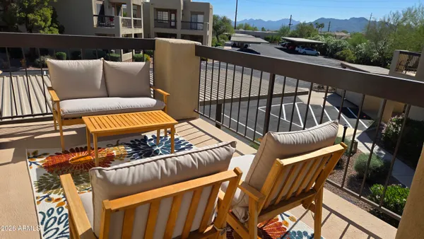 a view of a balcony with furniture