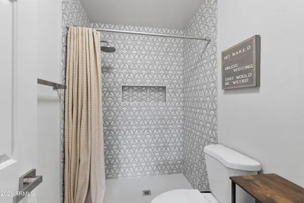 a bathroom with a shower and a toilet