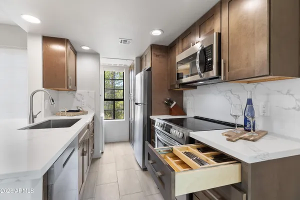 a kitchen with a sink stove and microwave