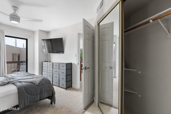 a bedroom with a bed and a large window