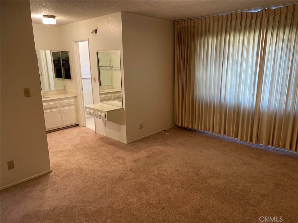 1110 Orange Avenue Monrovia, CA 91016 - Photo 13 of 14 an empty room with a cabinet and mirrors