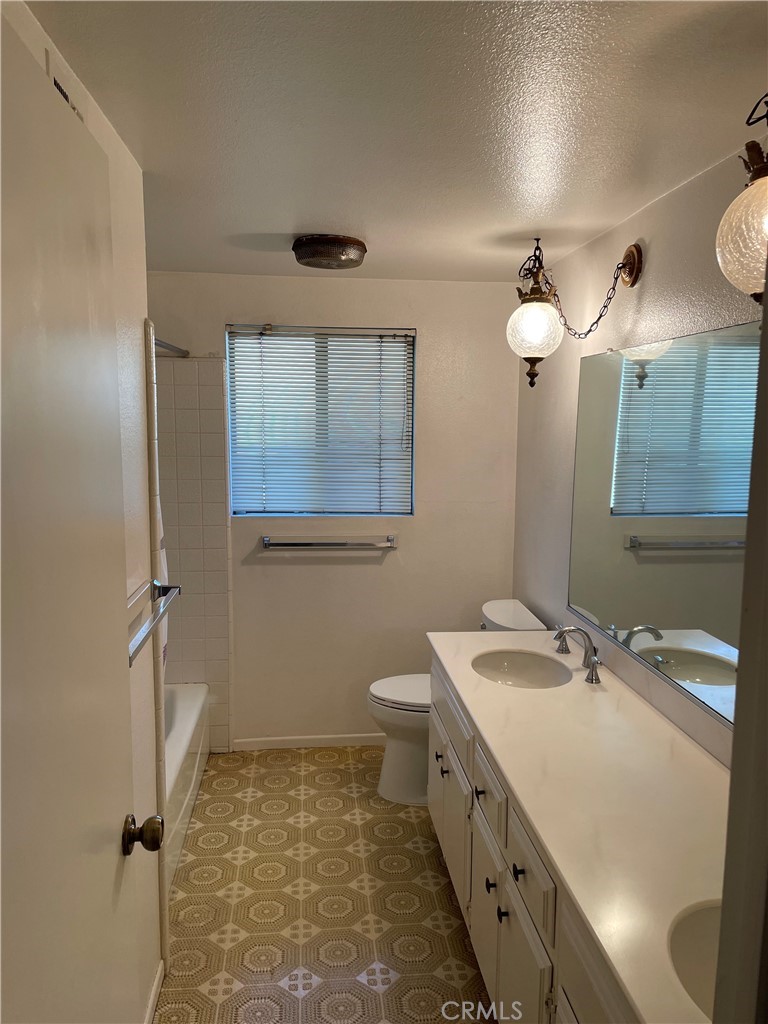 1110 Orange Avenue Monrovia, CA 91016 - Photo 14 of 14 a bathroom with a double vanity sink mirror and toilet
