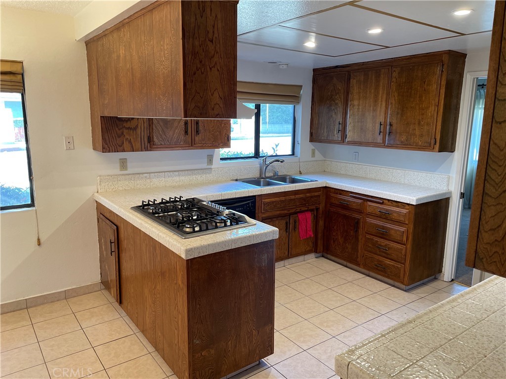 1110 Orange Avenue Monrovia, CA 91016 - Photo 8 of 14 a kitchen with a stove sink and cabinets