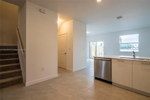 a view of a kitchen with wooden floor and electronic appliances