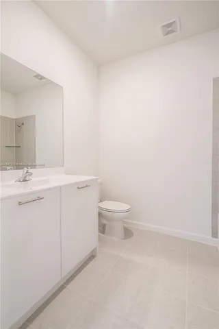 a bathroom with a sink a toilet and a vanity