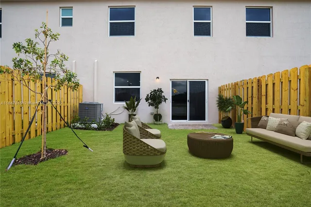 a living room with furniture and a garden