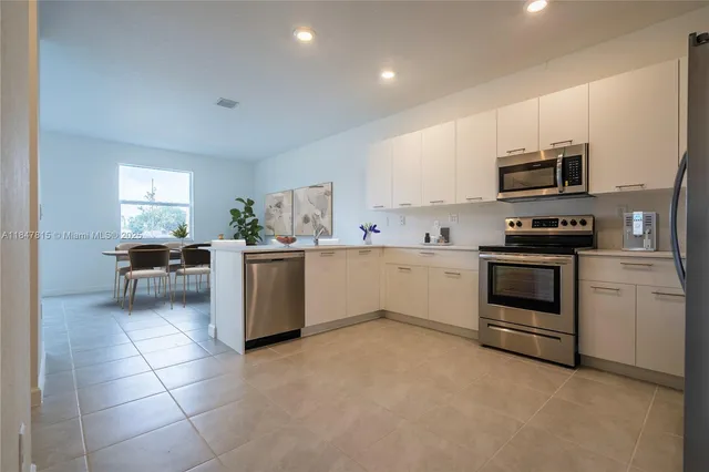 a kitchen with a stove top oven and cabinets