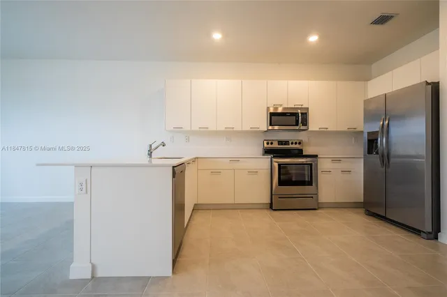 a kitchen with a refrigerator sink and stove