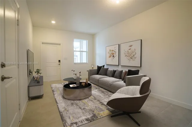 a living room with furniture rug and window