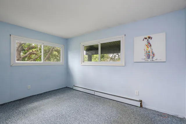 a view of an empty room with a window and a window