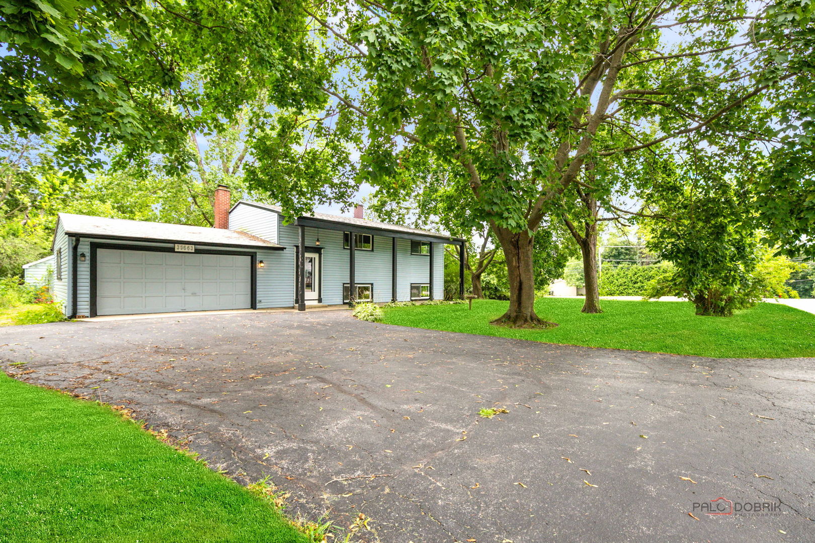 35663 North Helendale Road Ingleside, IL 60041 - Photo 25 of 28 a view of a house with a yard and large tree