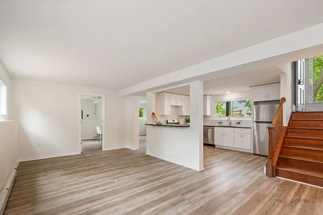 a kitchen with wooden floors and white appliances