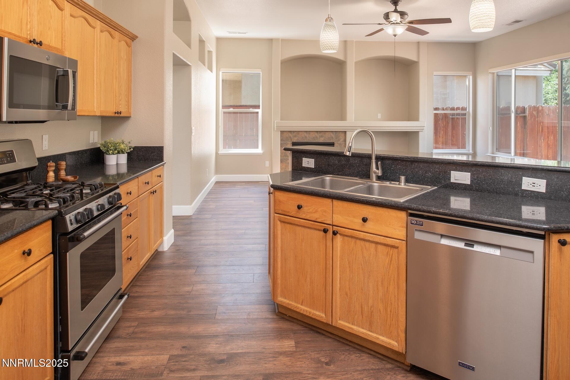 9579 Mammoth Court Reno, NV 89521 - Photo 13 of 39 a kitchen with stainless steel appliances granite countertop a sink stove and microwave