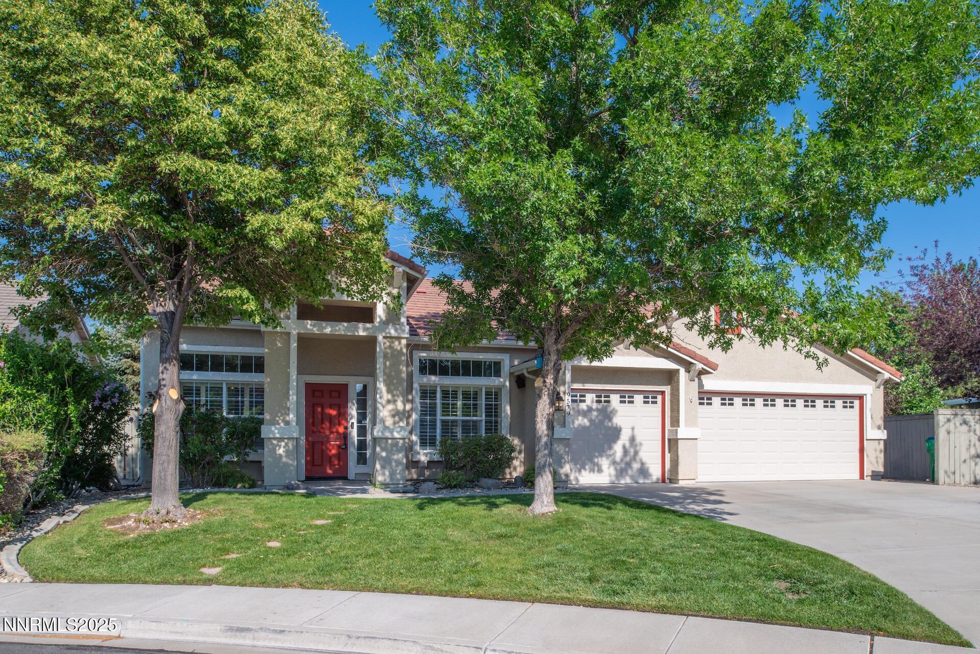 9579 Mammoth Court Reno, NV 89521 - Photo 2 of 39 a front view of a house with a garden and porch