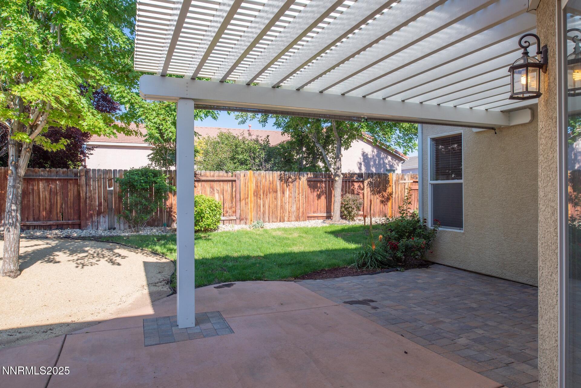 9579 Mammoth Court Reno, NV 89521 - Photo 24 of 39 a backyard of a house with a fountain plants and large tree