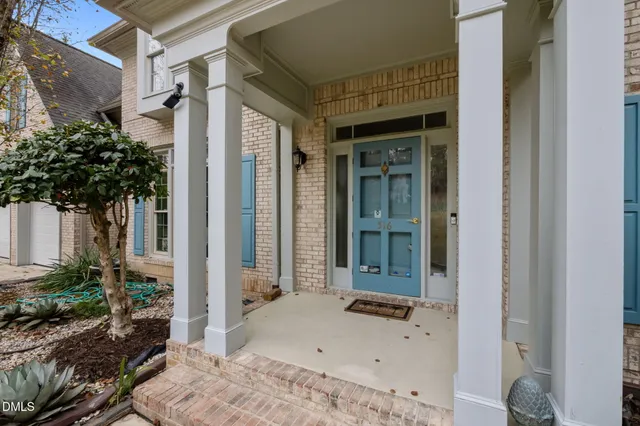 a view of an empty room with a fireplace and a window