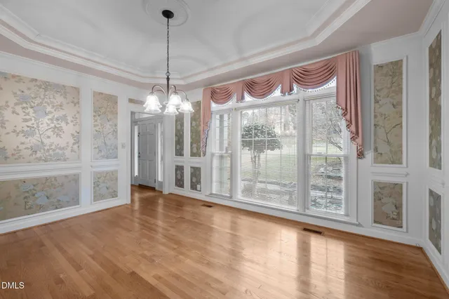 a large white kitchen with granite countertop a white stove top oven and white cabinets