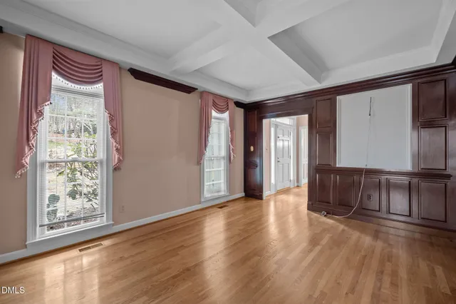a view of an empty room with a fireplace and a large window