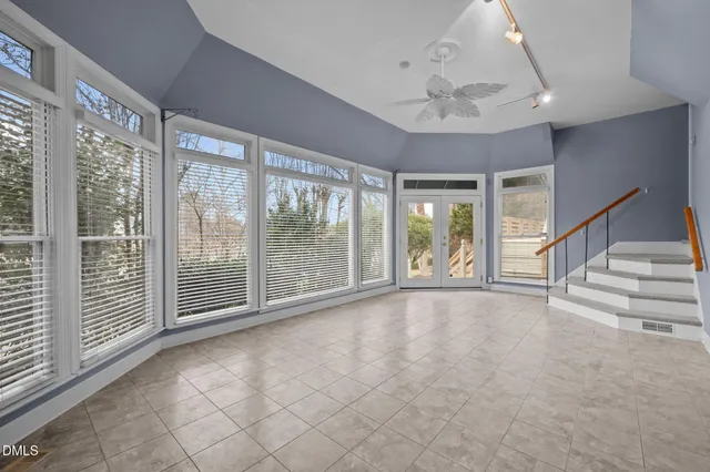 a view of an empty room with chandelier