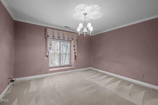 a view of a house with large tree and wooden fence