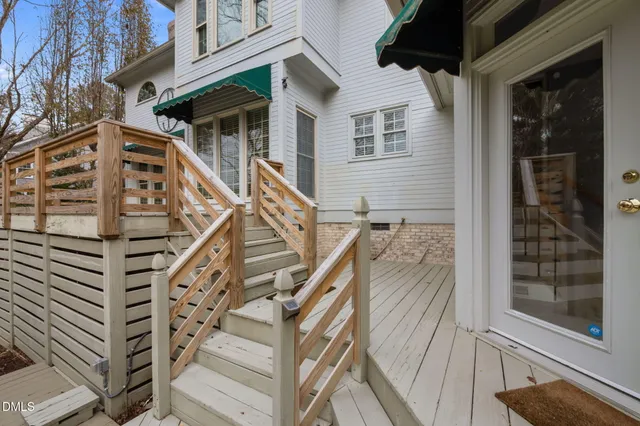 a view of a swimming pool with lawn chairs and a yard