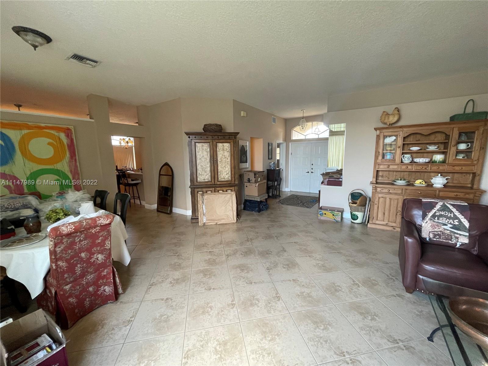 9252 Lake Serena Drive Boca Raton, FL 33496 - Photo 8 of 33 a living room with furniture and a flat screen tv