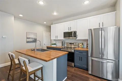 a kitchen with appliances cabinets and wooden floor