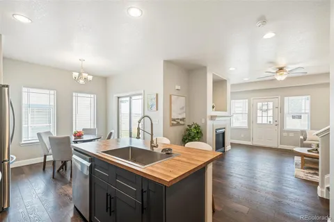 a kitchen with a table chairs sink and cabinets