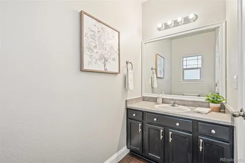 a bathroom with a double vanity sink and a mirror