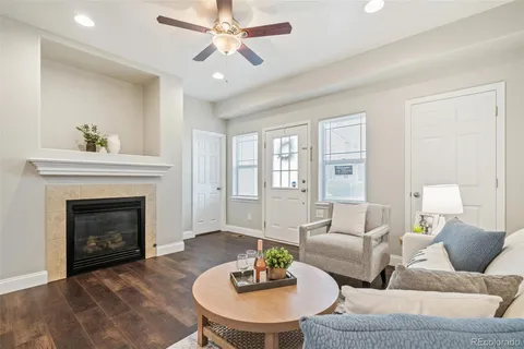 a living room with furniture a fireplace and a chandelier