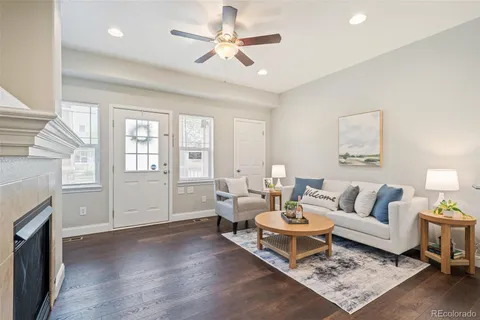 a living room with furniture a fireplace and a chandelier
