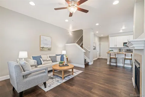 a living room with furniture and kitchen view