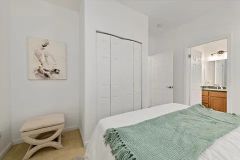 a bedroom with a bed and a chair
