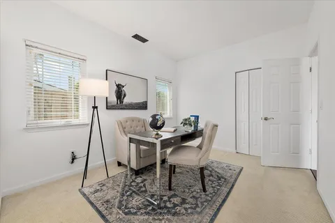 a view of a dining room with furniture and window