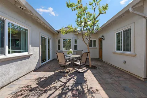 a view of a house with patio and a yard