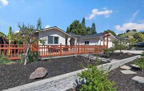 a front view of a house with yard and green space