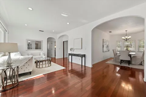 a living room with furniture and a wooden floor