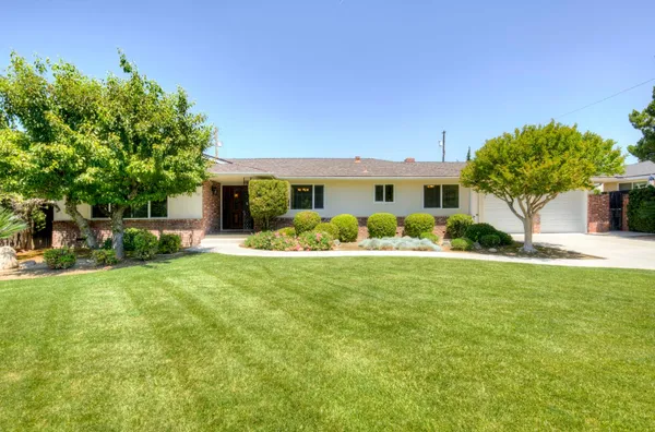 a front view of house with yard and outdoor seating