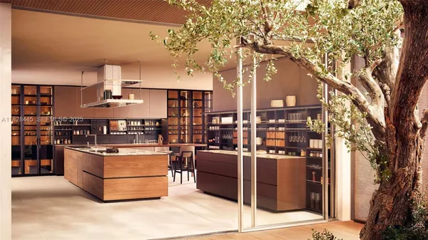 a living room with stainless steel appliances kitchen island a stove and a tree