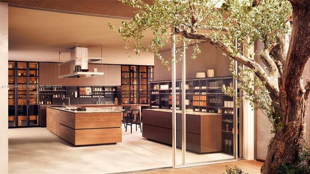 a living room with stainless steel appliances kitchen island a stove and a tree