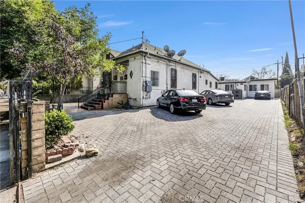 a view of a car park in front of a house