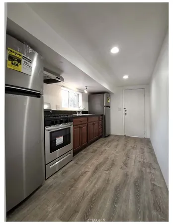 a view of kitchen appliances and cabinets