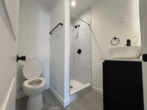 a bathroom with a toilet a sink and shower