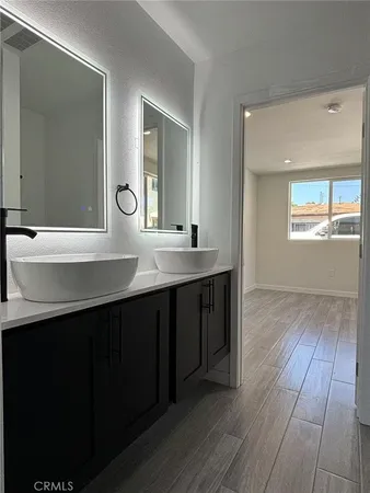 a bathroom with a double vanity sink and mirror