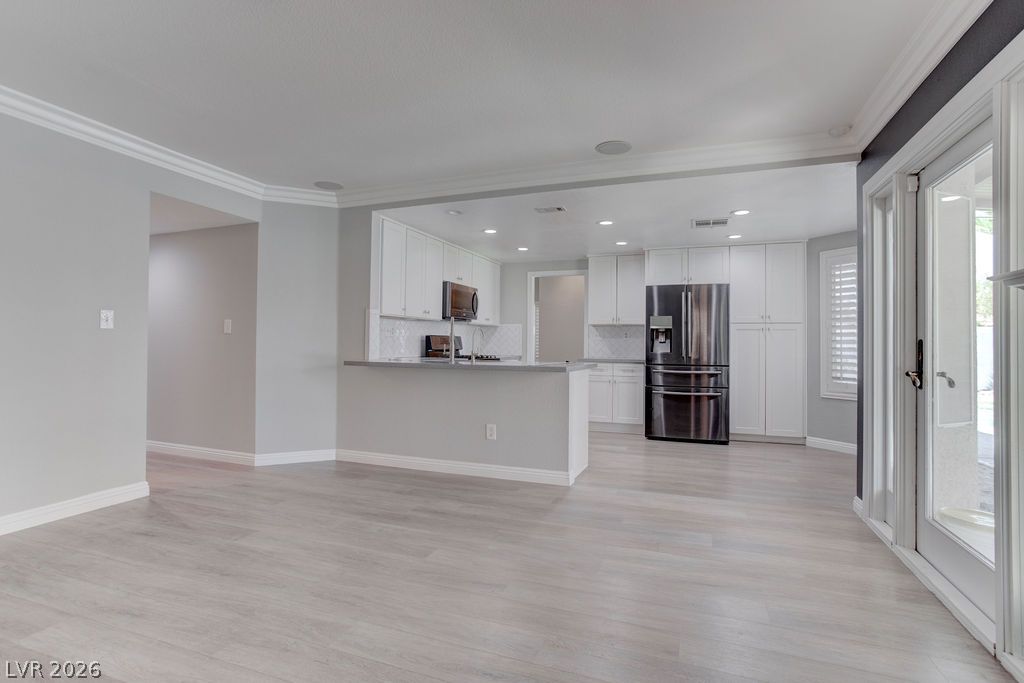 1416 Walstone Road North Las Vegas, NV 89031 - Photo 15 of 47 A contemporary open-concept layout unites the kitchen and living areas, offering effortless daily living.