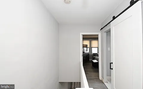 a view of hallway with bathroom