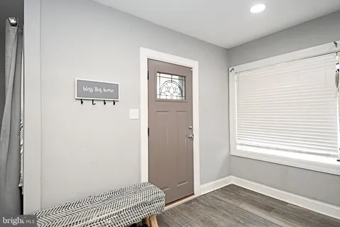 a view of a room with wooden floor and a window