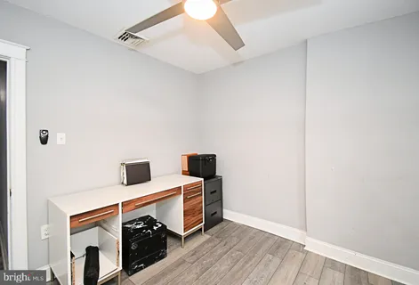 a view of a kitchen with a white cabinet and a fireplace